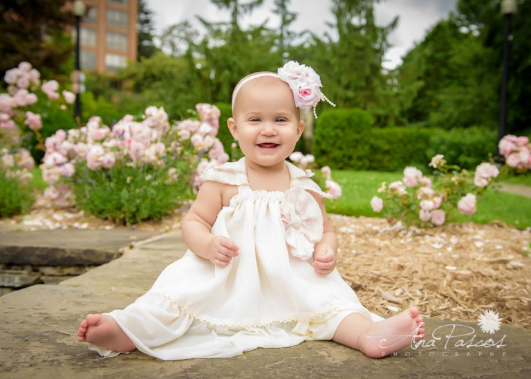 baby-girl-sitting-in-front-of-roses-for-outdoor-family-portraits-in-toronto